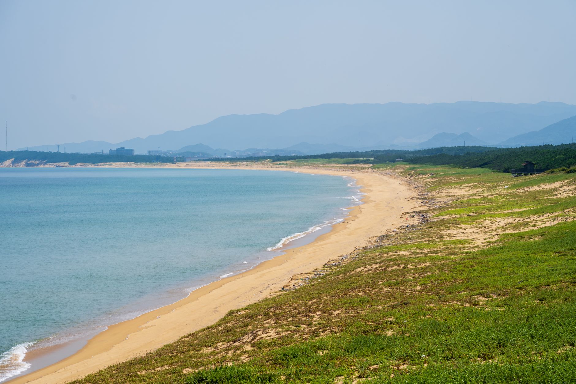scenic coastal beach with mountain views
